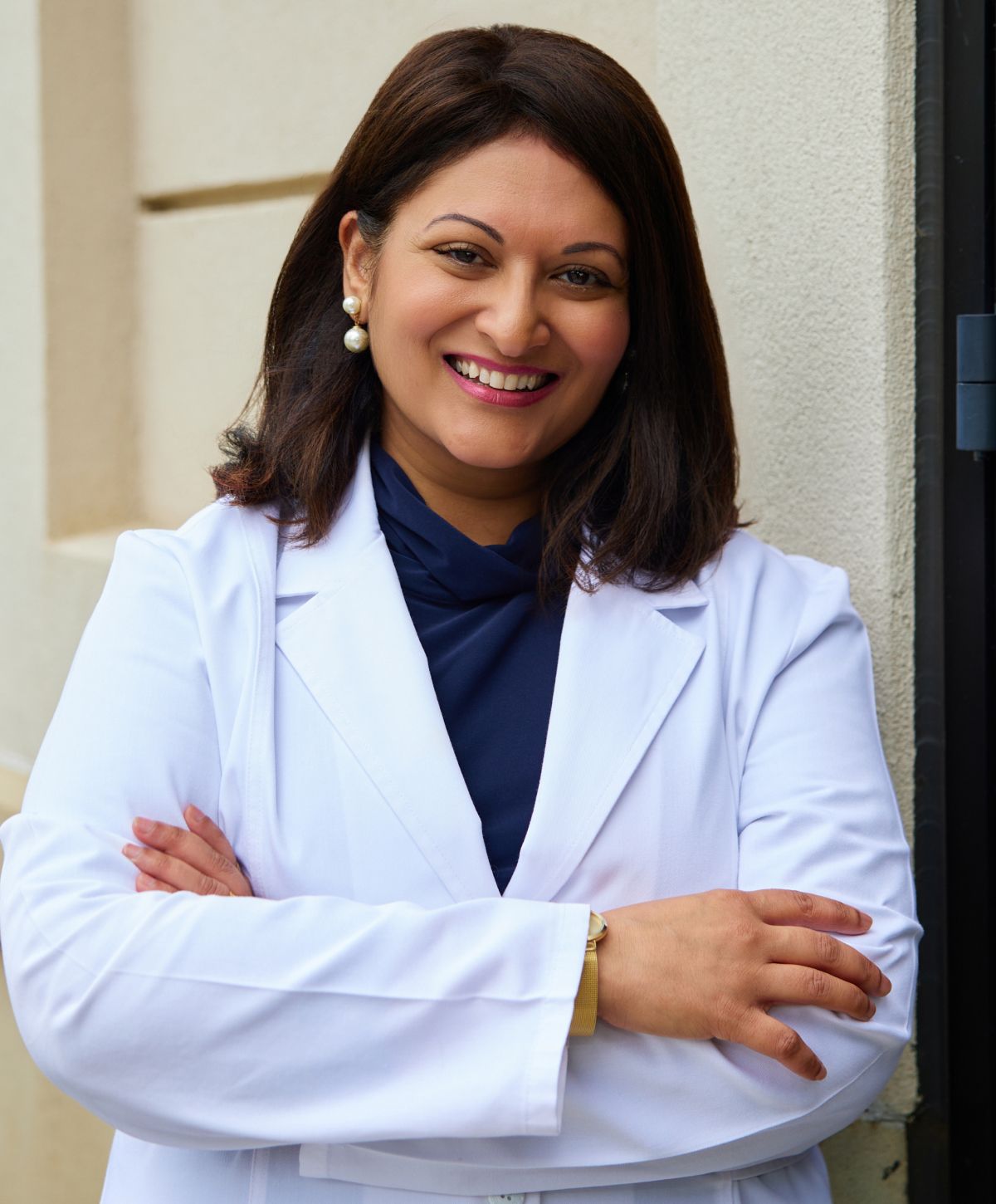 Smiling professional in a white lab coat.