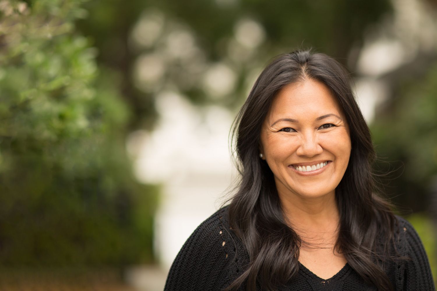 Alpharetta Bulkamid Injection model with wavy gray hair, portrait.